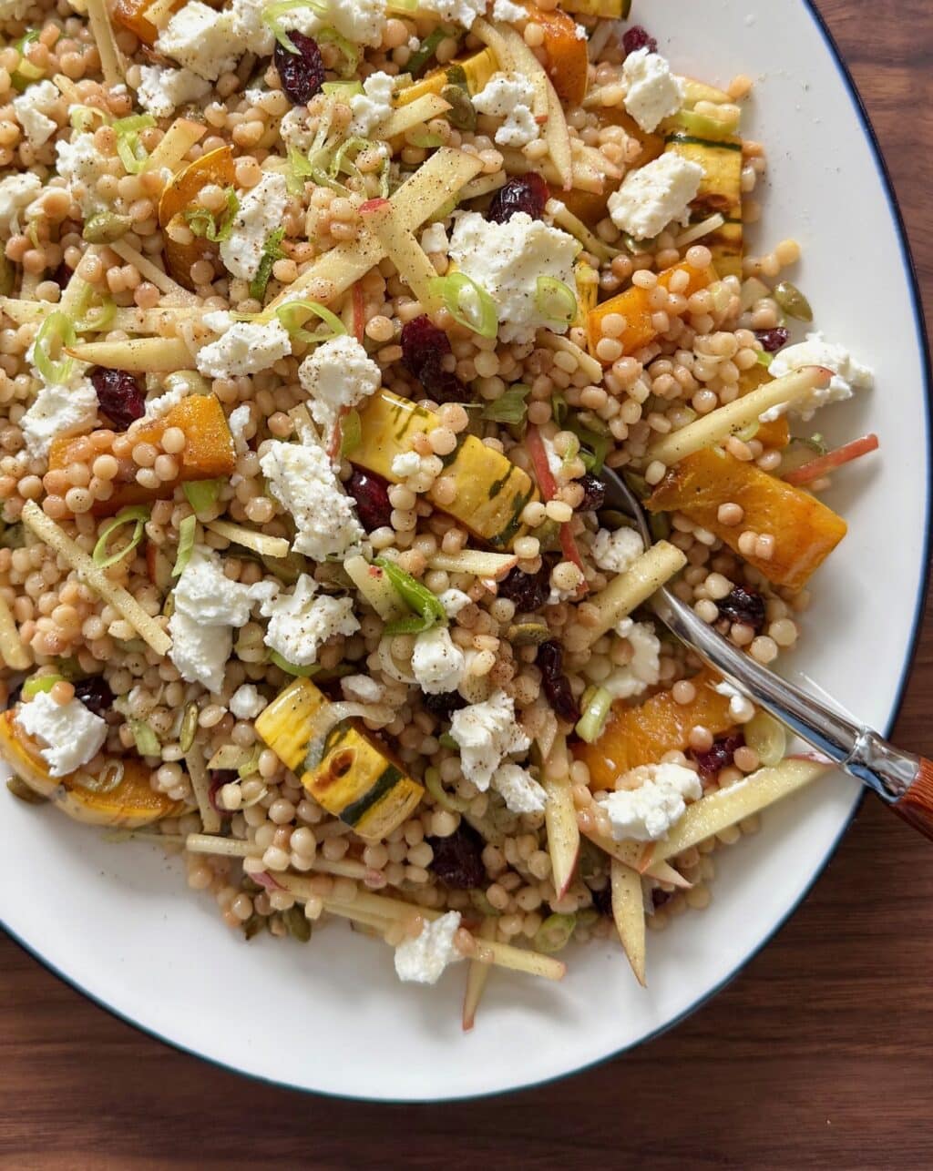 This is a close up of the fall couscous salad with delicata squash, apple, and cranberries.